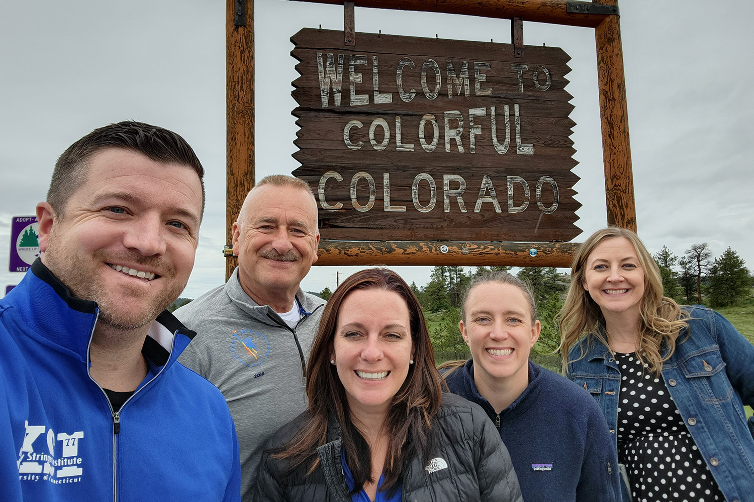 group in front of colorado sign