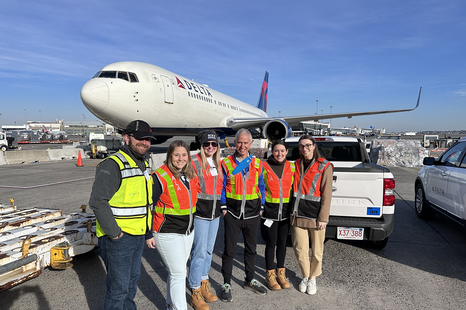 KSI group in front of a Delta airplane